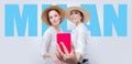 Portrait of two smiling women taking a selfie against the backdrop of a billboard with the inscription Royalty Free Stock Photo