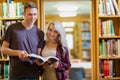 Portrait of two students reading book in the library Royalty Free Stock Photo