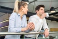 Portrait of two successful business people, man and woman, smiling and talking during coffee break in office building Royalty Free Stock Photo