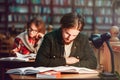 Portrait of Couple of Students in Library Royalty Free Stock Photo