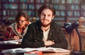 Portrait of Couple of Students in Library Royalty Free Stock Photo