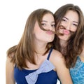 Portrait of a two teen girls have fun and make faces with moustache made of hair pigtail Royalty Free Stock Photo