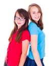 Portrait of two teen girls standing back-to-back Royalty Free Stock Photo