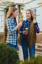 Portrait of two teenager girls standing together eating ice cream Royalty Free Stock Photo