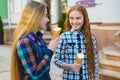 Portrait of two teenager girls standing together eating ice cream Royalty Free Stock Photo