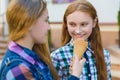 Portrait of two teenager girls standing together eating ice cream Royalty Free Stock Photo