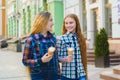 Portrait of two teenager girls standing together eating ice cream Royalty Free Stock Photo
