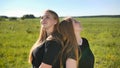 Portrait of two twin sisters in the field on a warm summer day Royalty Free Stock Photo