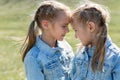 Portrait of two twin sisters who hug and look at each other Royalty Free Stock Photo