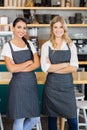 Portrait of two waitresses standing with arms crossed Royalty Free Stock Photo