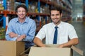 Portrait of two warehouse workers standing together with boxes Royalty Free Stock Photo