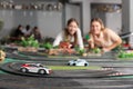 Portrait of two women playing with slot car racing track Royalty Free Stock Photo