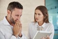 Two worried coworkers working together on tablet Royalty Free Stock Photo