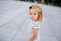 Portrait of a two year old girl in a striped dress.