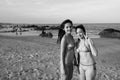 Two young happy beautiful Asian women smiling together at the beach Royalty Free Stock Photo