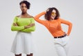 Two young beautiful hipster girls in colorful summer clothes Royalty Free Stock Photo