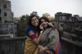 Portrait of two young Indian brunette girls/sisters/friends with traditional wear sari having fun on a rooftop Royalty Free Stock Photo