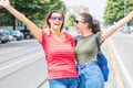 Portrait of two young beautiful lesbian smiling girls in a summer day whit colored t-shirt clothes and jeans Royalty Free Stock Photo