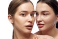 Portrait of two young beautiful young Caucasian woman with clean fresh skin against white studio background.