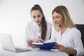 Portrait of two young businesswomen at a table Royalty Free Stock Photo