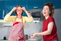 Portrait of two young caucasian women cook in the kitchen and have fun together. Indoors. Concept of joint home cooking Royalty Free Stock Photo