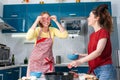 Portrait of two young Caucasian women cook pizza in the kitchen and have fun together. Indoors. Concept of joint home cooking for Royalty Free Stock Photo