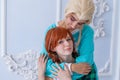 portrait of two young girls in white and red wigs on the background of a home interior Royalty Free Stock Photo