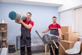 Portrait Of Two Young Male Movers Loading The Products Royalty Free Stock Photo