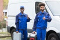 Portrait Of Two Young Manual Worker With Their Tool Boxes