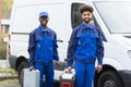 Portrait Of Two Young Manual Worker With Their Tool Boxes