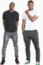 Portrait of two young men in casuals over gray background Royalty Free Stock Photo