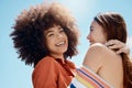 Portrait of two young mixed race female friends embrace and smiling outside on a sunny day. A Beautiful gay hispanic Royalty Free Stock Photo