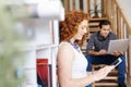 Portrait of two young people sitting at the stairs in office Royalty Free Stock Photo