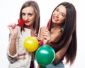 Portrait of two young pretty hipster girls holding candys.