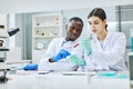 Two young technicians working with samples in laboratory Royalty Free Stock Photo