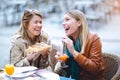 Portrait of two young women eating pizza outdoors Royalty Free Stock Photo