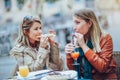 Portrait of two young women eating pizza outdoors Royalty Free Stock Photo