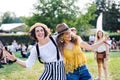 Portrait of two young women friends standing at summer festival. Royalty Free Stock Photo