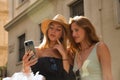 Portrait of two young women looking at the cell phone of one of them pensively Royalty Free Stock Photo