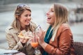 Portrait of two young women meating in cafe eating pizza outdoors Royalty Free Stock Photo