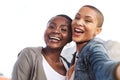 Happy girls are the best. Portrait of two young women smiling and posing while taking a selfie in the city. Royalty Free Stock Photo