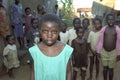 Portrait of Ugandan girl with friends in background