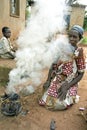 Portrait of Ugandan woman, fire and smoke