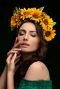 Portrait of a Ukrainian girl in a wreath of colorful yellow sunflowers. National traditional flower headdress. Ukraine