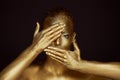 Portrait unearthly Golden girls, hands near the face. Very delicate and feminine. The eyes are open. Frame of hands Royalty Free Stock Photo