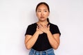 Portrait of uneasy young woman touching her chest