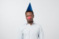 Portrait of unhappy african man with a red nose celebrating all fools day Royalty Free Stock Photo