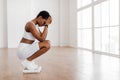 Portrait of Unhappy African Woman Standing On Bathroom Scales Royalty Free Stock Photo