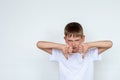 Portrait of unhappy, angry, displeased child giving thumbs down hand gesture, isolated white background Royalty Free Stock Photo