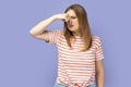 Unhappy attractive woman standing and pinching her nose, smelling, feels negative odor. Royalty Free Stock Photo